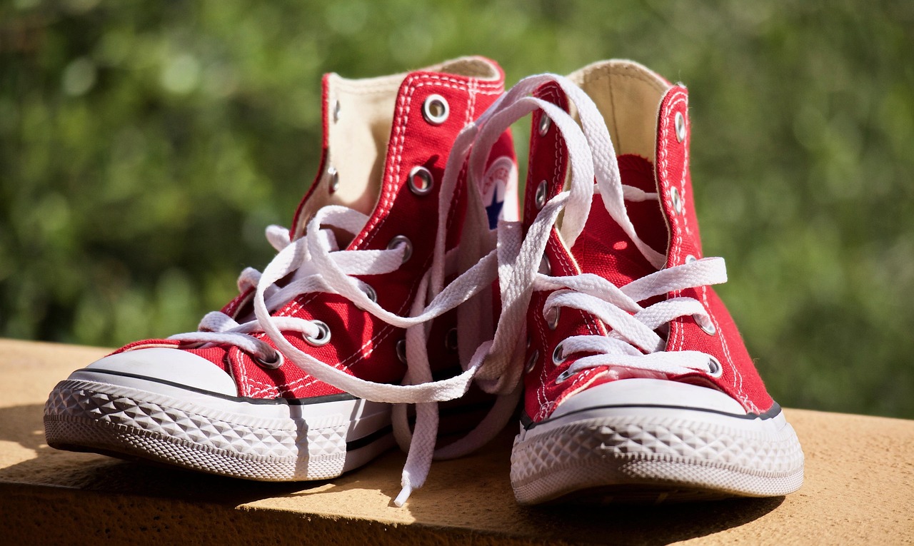Red sports trainers on a dark background