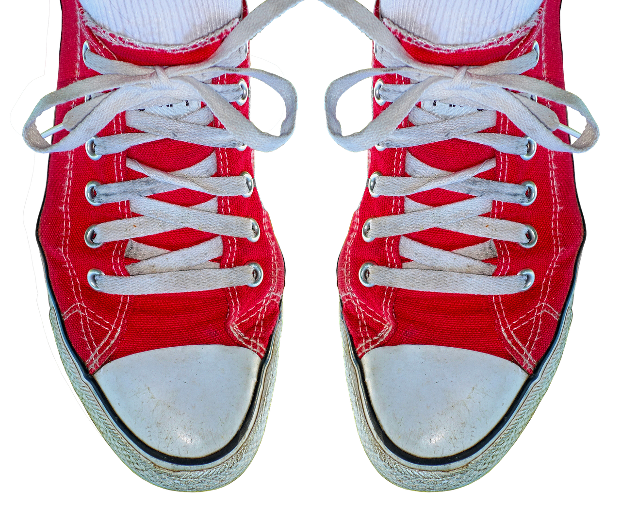 Red and white trainers on a plain background